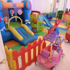 This indoor setup features a large bouncy castle with a slide, a seesaw, and a princess-themed ride-on cart. It’s a perfect combination for a birthday party, offering both active and imaginative play options.