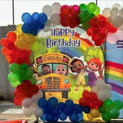 A closer view of the Cocomelon party setup, showing the school bus backdrop and colorful balloon arrangement.