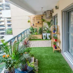 This balcony design concept shows how to maximize a long, narrow space with artificial turf, a vertical garden wall, and tiered planters to create a green oasis in an apartment.