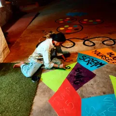 Painting through the night to get this interactive mural ready. The design includes instructions like "Jump x5" and "Scream," turning the floor into a game controller.