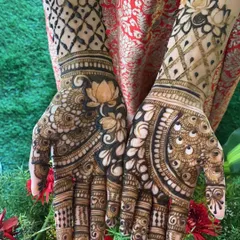 This design beautifully combines lotus motifs with a delicate jaal pattern on the forearm, blending floral and geometric styles.