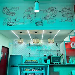 This doodle wall at Café Quaint tells the story of its journey. We mapped out key moments in the café's history, and I brought them to life with flowing lines and illustrations, creating a unique piece of storytelling wall art that is now a part of their space.
