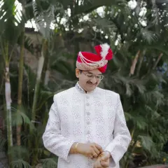 The groom checks his cuffs, another stylish getting-ready shot that captures the small details of his attire.