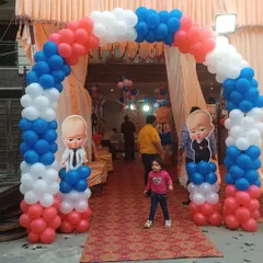 A grand entrance arch for a Boss Baby themed party. I used red, white, and blue balloons to create the arch, with Boss Baby character cutouts on the pillars to welcome guests.