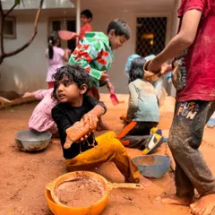 A busy afternoon in the mud kitchen. Children are fully engaged, mixing, pouring, and creating, their imaginations running wild.