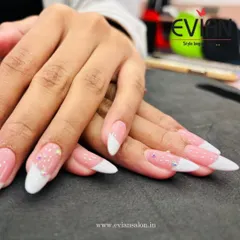 You can never go wrong with a classic French manicure. Here, I've given it a modern twist with a soft pink base, crisp white tips on almond-shaped extensions, and a few carefully placed rhinestones for a touch of sparkle.