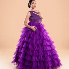 Another look at the stunning purple ruffled gown, showcasing its structure and the way the light catches the sequined top.