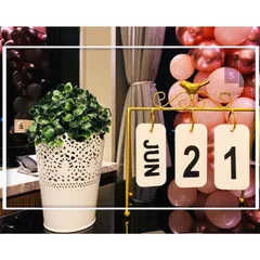 We love adding personal touches like this vintage-style flip calendar, set to the couple's special date of June 21st. It's a small detail that adds great sentimental value to anniversary decorations.