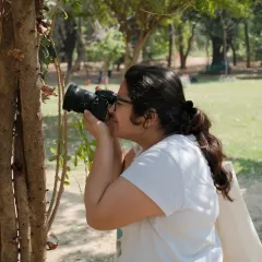 Me taking a close-up shot of a tree, finding beauty in the small details. Photography has taught me to see the world differently.