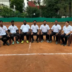 The coaching team taking a moment on the court. We are always there, observing, guiding, and pushing our players to achieve their best.