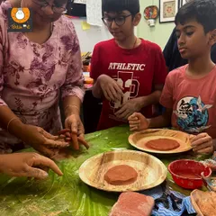 Here I am guiding students as they learn to roll and shape clay coils. This foundational pottery technique is a great hands-on way to connect with history and art.