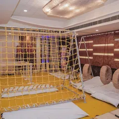 An indoor adventure zone featuring a rope climbing net and tire swings. I can transform an indoor space into a challenging and fun obstacle course.