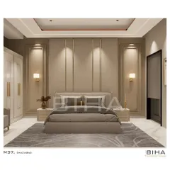 We designed this master bedroom in Ghaziabad as a sanctuary of minimalist elegance. The design centers on a symmetrical, floor-to-ceiling upholstered back panel with integrated brass accents and soft wall sconces. The recessed cove lighting in the ceiling casts a gentle glow, enhancing the serene and calming color palette.