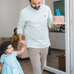 Here comes the cake. Capturing a toddler's birthday party at home allows for authentic, story-telling images of your family's special day.