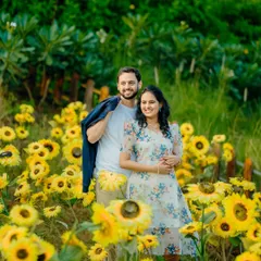 A vibrant and joyful pre-wedding shot of Sayali and Siddhesh in a field of sunflowers. This natural, colorful setting is perfect for fun and happy couple portraits.