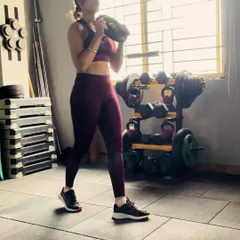 A snapshot from a training session, holding a weight plate for a goblet squat. This exercise is amazing for building lower body strength, particularly in the quads and glutes, while also engaging the core to keep the torso upright.