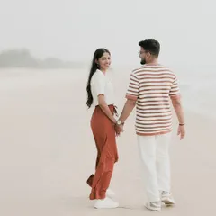A classic "follow me" shot while walking along the shoreline. This style of photography creates a sense of journey and togetherness, perfect for a pre-wedding album.