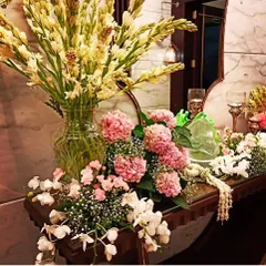 A luxurious floral setup for a home or event, featuring a large vase of fragrant tuberoses alongside an arrangement of pink hydrangeas and white orchids. This type of decor adds elegance to any space.