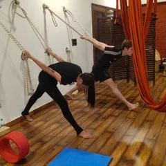 Our International Yoga Teacher Training Course is now open for enrollment. This image shows students practicing a supported side-angle pose using the wall ropes, a technique you will master in our 200/300-hour programs.