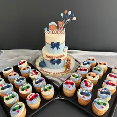 A perfect pairing for a little one's birthday. This set features a two-tier teddy bear and train themed cake, personalized for Kritveda's celebration, accompanied by adorable matching cupcakes with little car toppers.