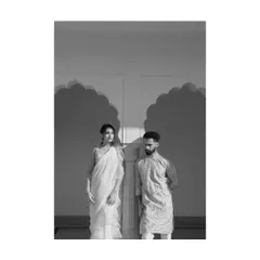 A striking black and white portrait of a couple, using the strong shadows of Indian arches to create a graphic and modern composition.