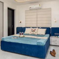 I love how this fresh and elegant royal blue bedroom turned out. The plush, upholstered bed frame adds a touch of luxury, while the neutral walls and flooring keep the space feeling bright and airy.