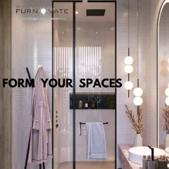 Another view of the stylish pink bathroom, showing the glass shower partition and black fixtures that provide a modern contrast to the soft color palette.