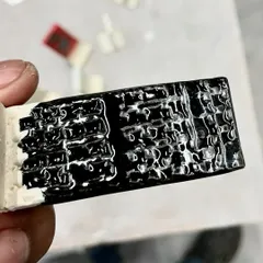 This glaze test shows a thick, glossy black glaze that has crawled and beaded up, creating a rich, bumpy texture. It's these happy accidents that often lead to the most interesting results.
