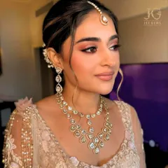 A bridal vision in soft hues. This bride glows in our delicate Polki necklace set, featuring uncut diamonds that offer a subtle, yet breathtaking, sparkle for her big day.