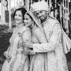 A touching black and white photo of a groom embracing his bride and her mother. This image beautifully captures the joining of two families and the deep emotional bonds shared on a wedding day.