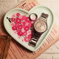 A hand-painted cherry blossom design on our mint green heart tray. This piece showcases our custom art service, where we paint delicate florals to create a truly personal trinket dish for your most loved jewelry and watches.