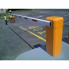 A heavy-duty boom barrier installed to manage vehicular traffic at an entry point. These systems are essential for controlling access in parking lots, corporate campuses, and residential communities, and can be integrated with FASTAG or RFID readers.