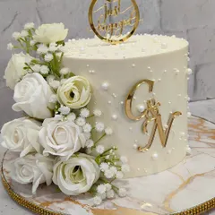From this angle, you can see the beautiful texture and the elegant "Just Engaged" topper that completes this sophisticated celebration cake.