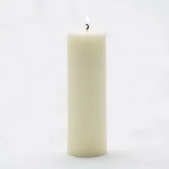 A single, tall white pillar candle lit to show its steady, clean-burning flame. I use high-quality paraffin wax to ensure a long-lasting and consistent burn for all my candles.
