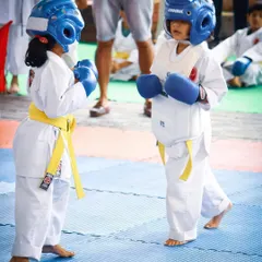 Even our youngest students, starting from age 4, get to experience the thrill of competition. Dressed in full safety gear, they learn the fundamentals of sparring in a supportive setting.