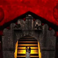 A creative frame-within-a-frame shot at a historic fort. The dramatic red and the ancient stone archway create a powerful, artistic, and unforgettable pre-wedding image.