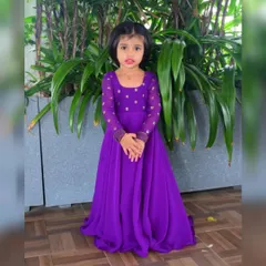 A full look at the custom purple gown. The square neckline and long, embellished sleeves add a sophisticated touch, making it a standout piece for any special celebration or photoshoot.