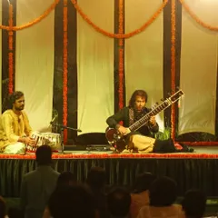 On stage with Ustad Rafique Khan saheb during a sitar recital at the Courtyard Baithak series. My focus is always on the main artist, listening closely to respond to their musical ideas.