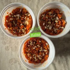 Three bowls of warm Gajar ka Halwa, generously garnished with chopped almonds. It's a perfect dessert to share with family.