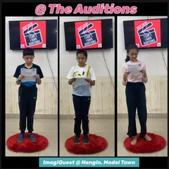 Auditions in progress for "The Dream Chasers" theatrical. Young actors stand on red mats, reading their scripts and getting into character as they try out for a role in the upcoming stage show.