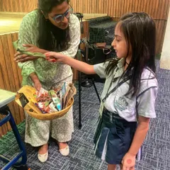 A student at St. Xavier's participates in our waste segregation game. By sorting through a basket of mixed waste, children learn to identify what is recyclable, what is compostable, and what needs to be disposed of responsibly.