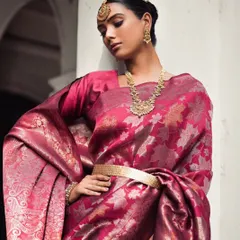 A regal pose in a magenta Banarasi silk saree. The styling focuses on the luxurious fabric and traditional jewellery, creating a powerful and timeless image of Indian elegance.