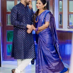 A gorgeous South Indian engagement look. The bride is decked out in a traditional blue Kanjeevaram saree with temple jewelry, complemented by a classic makeup look and a floral hairstyle.