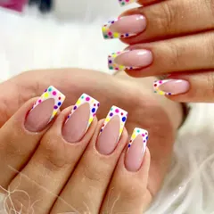 French tips? Nah, funfetti tips! This playful design features a classic French manicure shape but with a white tip covered in colorful polka dots for a fun and celebratory look.