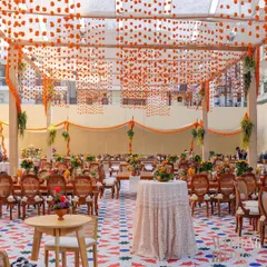 We brought the vibrant soul of Old Delhi to a sun-drenched brunch. This wide view captures the full experience, from the custom-printed flooring and tented ceiling with hanging marigolds to the comfortable seating areas, creating a perfect setting for a festive chaat party.