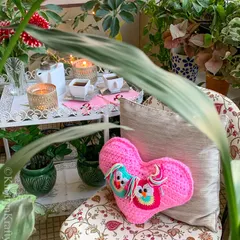 A peek at my Valentine's owl cushion, nestled amongst the plants on my balcony. It adds a sweet, romantic touch to this cozy outdoor space.
