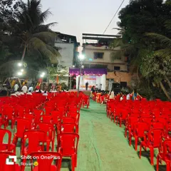 Rows of red plastic chairs set up for an outdoor live singing event. I can provide and arrange seating for any number of guests.