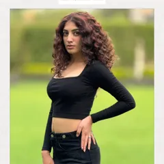 A textured haircut designed to give curls volume, shape, and definition. The face-framing layers and defined curls create a bold and confident look.
