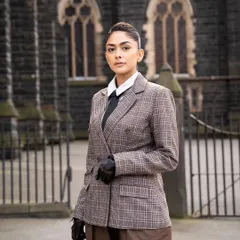 The full look of the custom plaid suit, set against a beautiful architectural backdrop in Melbourne.