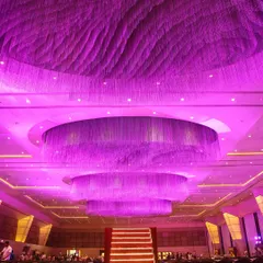 A night where every light hit just right. The centerpiece of this sangeet was a colossal, custom-built chandelier installation that bathed the entire hall in a vibrant purple glow, creating a truly electric atmosphere.